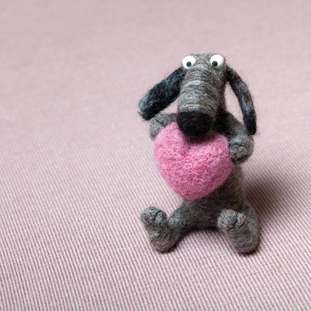 Wool Grey Felted Dog in Love Holding Heartの写真素材
