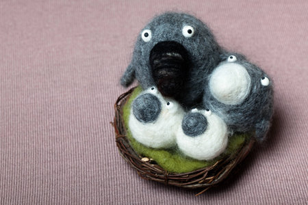 Felted Woolen Birds Family Sitting in the Nestの写真素材