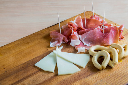ham and cheese on wooden boardの写真素材