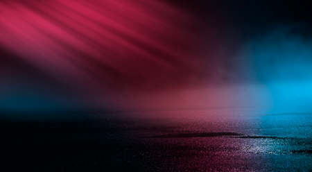 Neon futuristic landscape of a night street with neon light reflected in the water. Urban neon abstraction. Dark street wet asphalt reflections of rays.の写真素材