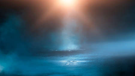 Dark street wet asphalt reflections of rays in the water Abstract dark blue background smoke smog Empty dark scene neon light spotlightsの写真素材