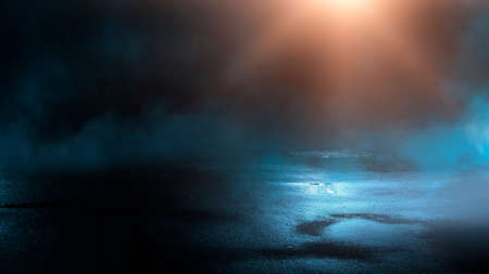 Dark street wet asphalt reflections of rays in the water Abstract dark blue background smoke smog Empty dark scene neon light spotlightsの写真素材