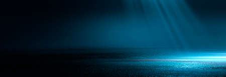 Dark street wet asphalt reflections of rays in the water Abstract dark blue background smoke smog Empty dark scene neon light spotlightsの写真素材