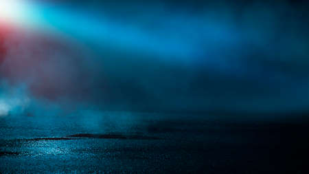 Dark street wet asphalt reflections of rays in the water Abstract dark blue background smoke smog Empty dark scene neon light spotlightsの写真素材