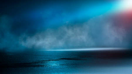 Dark street wet asphalt reflections of rays in the water Abstract dark blue background smoke smog Empty dark scene neon light spotlightsの写真素材