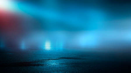 Dark street wet asphalt reflections of rays in the water Abstract dark blue background smoke smog Empty dark scene neon light spotlightsの写真素材