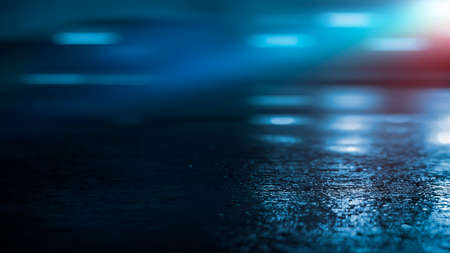 Dark street wet asphalt reflections of rays in the water Abstract dark blue background smoke smog Empty dark scene neon light spotlightsの写真素材