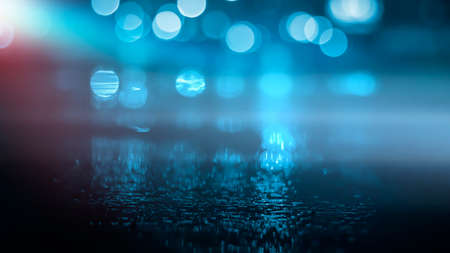 Dark street wet asphalt reflections of rays in the water Abstract dark blue background smoke smog Empty dark scene neon light spotlightsの写真素材