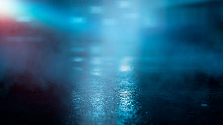 Dark street wet asphalt reflections of rays in the water Abstract dark blue background smoke smog Empty dark scene neon light spotlightsの写真素材