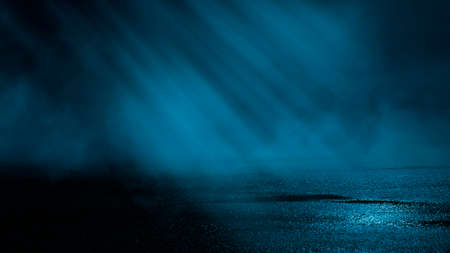 Dark street wet asphalt reflections of rays in the water Abstract dark blue background smoke smog Empty dark scene neon light spotlightsの写真素材