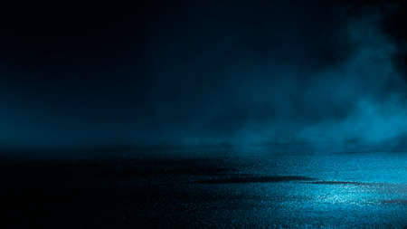 Dark street wet asphalt reflections of rays in the water Abstract dark blue background smoke smog Empty dark scene neon light spotlightsの写真素材