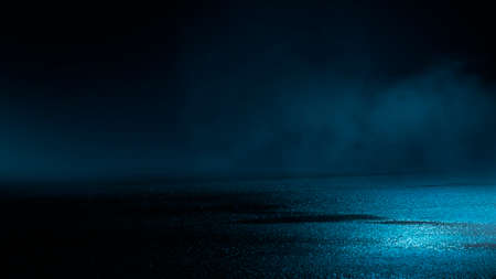 Dark street wet asphalt reflections of rays in the water Abstract dark blue background smoke smog Empty dark scene neon light spotlightsの写真素材