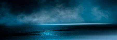 Dark street wet asphalt reflections of rays in the water Abstract dark blue background smoke smog Empty dark scene neon light spotlightsの写真素材