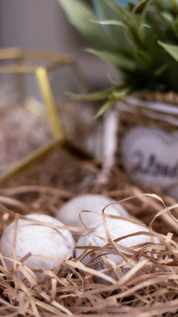 Decorative nest with colored Easter eggs in gray. Festive background, Happy Easter. Easter card. Painted eggs, gray marble texture.の写真素材