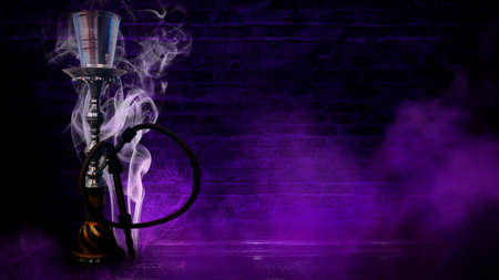 hookah on the background of a brick wall, neon light, smoke, smogの写真素材