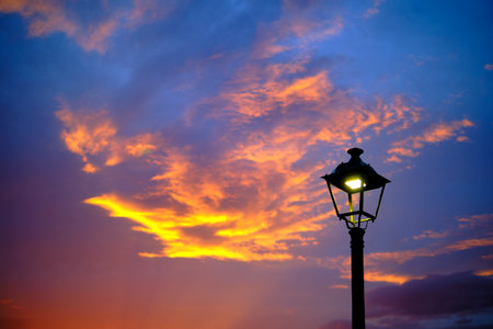 streetlight and sky with clouds at sunsetの写真素材