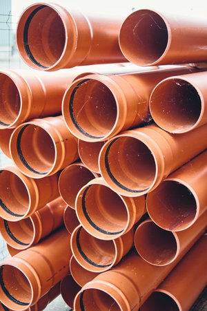 Orange pile of pipes in an industrial area.の写真素材