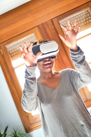 Young black woman testing a virual reality device.
