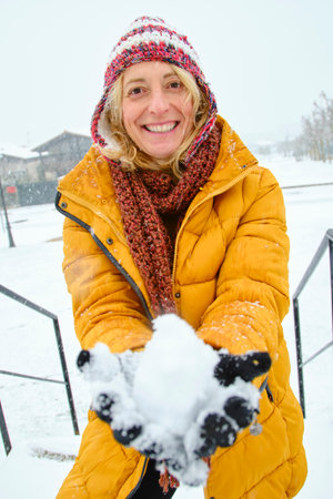 Young woman enjoying snow outdoor.