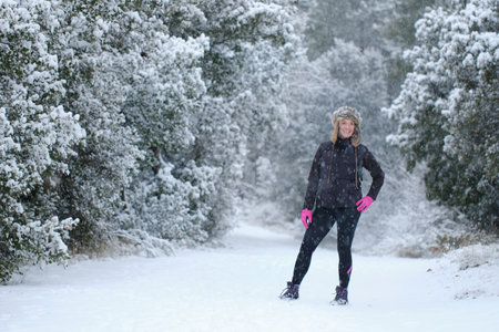 Young woman enjoying in snow outdoor.の写真素材