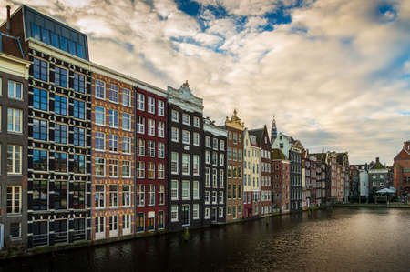 Amsterdam typical buildings with sky and water canals, Netherlandsの写真素材