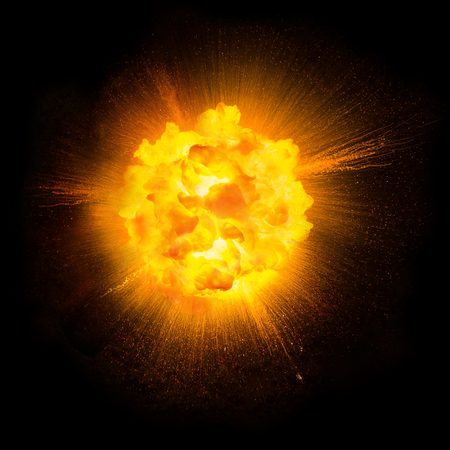 Realistic fiery explosion with sparks over a black backgroundの写真素材
