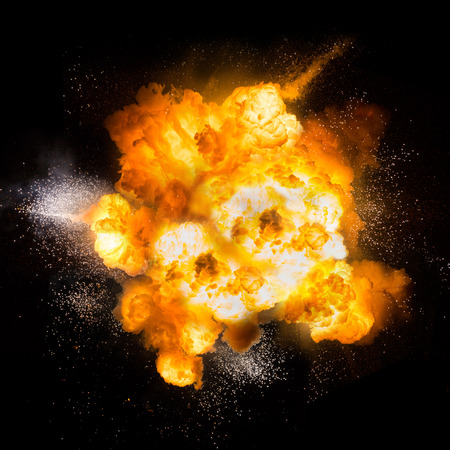 Realistic fiery explosion with sparks over a black backgroundの写真素材