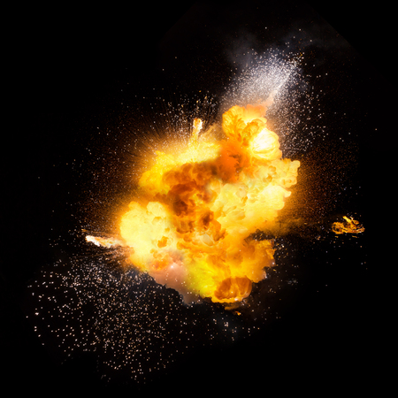 Realistic fiery explosion with sparks over a black backgroundの写真素材