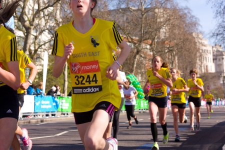 LONDON - APRIL 13: Unidentified girls run the London marathon on April 13th, 2013 in London, England, UK. The marathon is an annual event. のeditorial素材