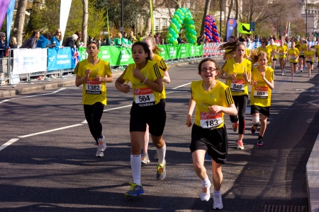 LONDON - APRIL 13: Unidentified girls run the London marathon on April 13th, 2013 in London, England, UK. The marathon is an annual event. のeditorial素材
