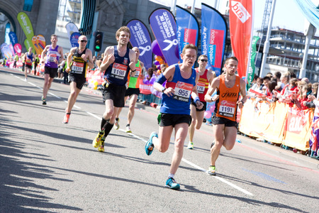 LONDON - APRIL 13: Unidentified men run the London marathon on April 13, 2014 in London, England, UK. The marathon is an annual event. のeditorial素材