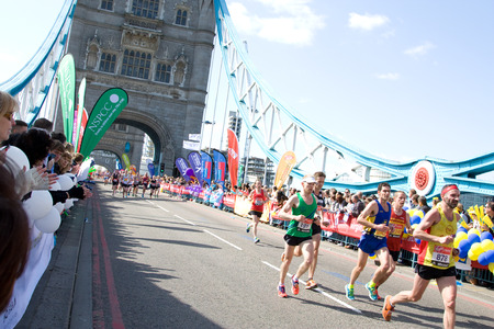 LONDON - APRIL 13: Unidentified men run the London marathon on April 13, 2014 in London, England, UK. The marathon is an annual event. のeditorial素材