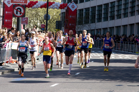 LONDON - APRIL 13: Unidentified men run the London marathon on April 13, 2014 in London, England, UK. The marathon is an annual event. のeditorial素材