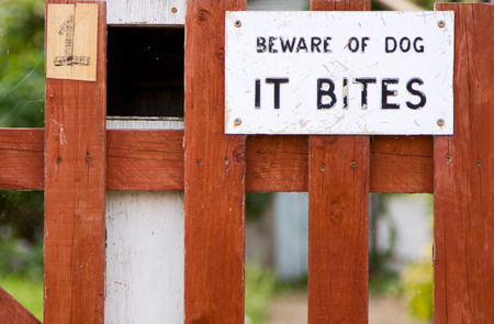 dog bites sign on a garden gate.の写真素材