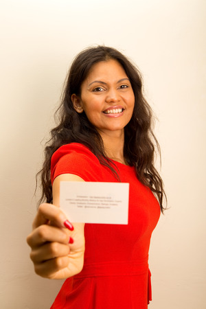 casual woman offering business card.の写真素材