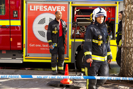 LONDON - OCTOBER 11TH: The fire brigade attend an emergency in waterloo on October 11th, 2014 in London, England, UK. Londons fire and rescue service is the busiest in the countryのeditorial素材
