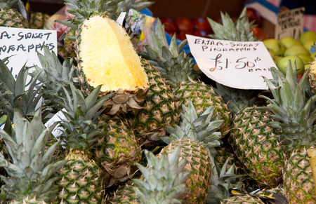 fresh pineapples at a market stall.のeditorial素材