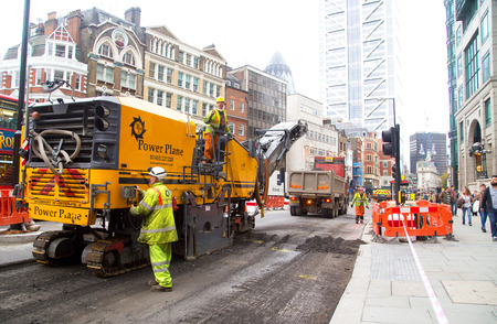 LONDON - OCTOBER 18TH: Unidentified workman using a cold milling machine on October 18th, 2014 in London, England, UK. Power Plane are the most modern Wirtgen planing fleet in the UKのeditorial素材