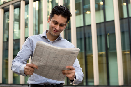 young man reading the newspaperの写真素材