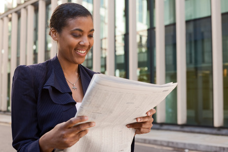 young business woman reading the newspaper.の写真素材