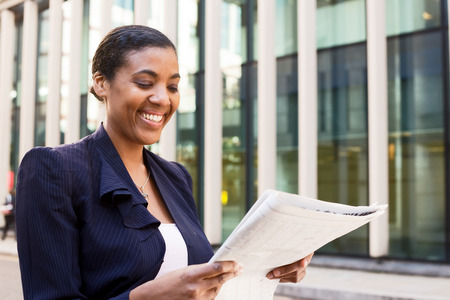 young business woman reading the newspaperの写真素材