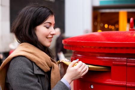 young woman posting lettersの写真素材