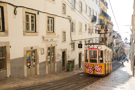 LISBON - JANUARY 9TH: An old traditional tram on January the 9th, 2015, in Lisbon, Portugal. Lisbon's number 28 tram is one of the city's cultural attractions.のeditorial素材