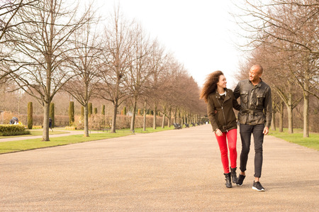 young couple walking in the parkの写真素材