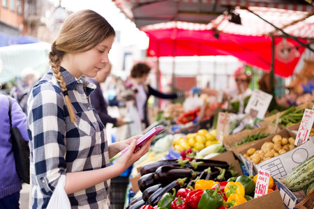 young woman reading her shopping listのeditorial素材