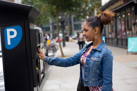 young woman paying her parking ticketの写真素材