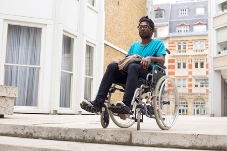 young man in a wheelchair at the top of steps