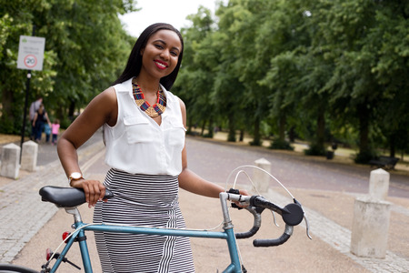 young woman in the park with her bikeの写真素材