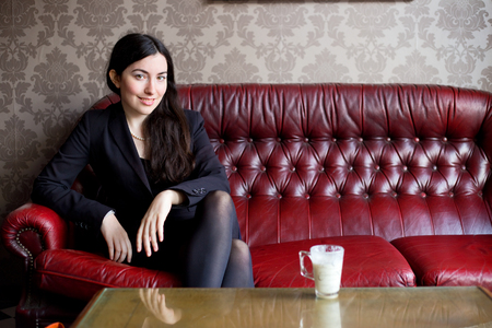 relaxed girl sitting on a sofaの写真素材