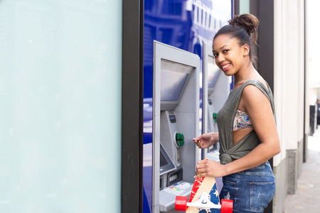 young woman at the cash machineの写真素材